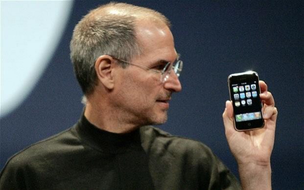 Steve Jobs holding first iPhone