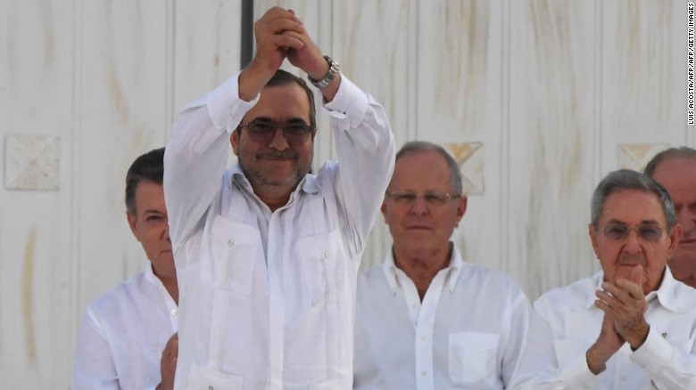 The head of the FARC, Timoleon Jimenez, aka Timochenko, gestures as he signs the historic peace agreement with the Colombian government on September 26, 2016